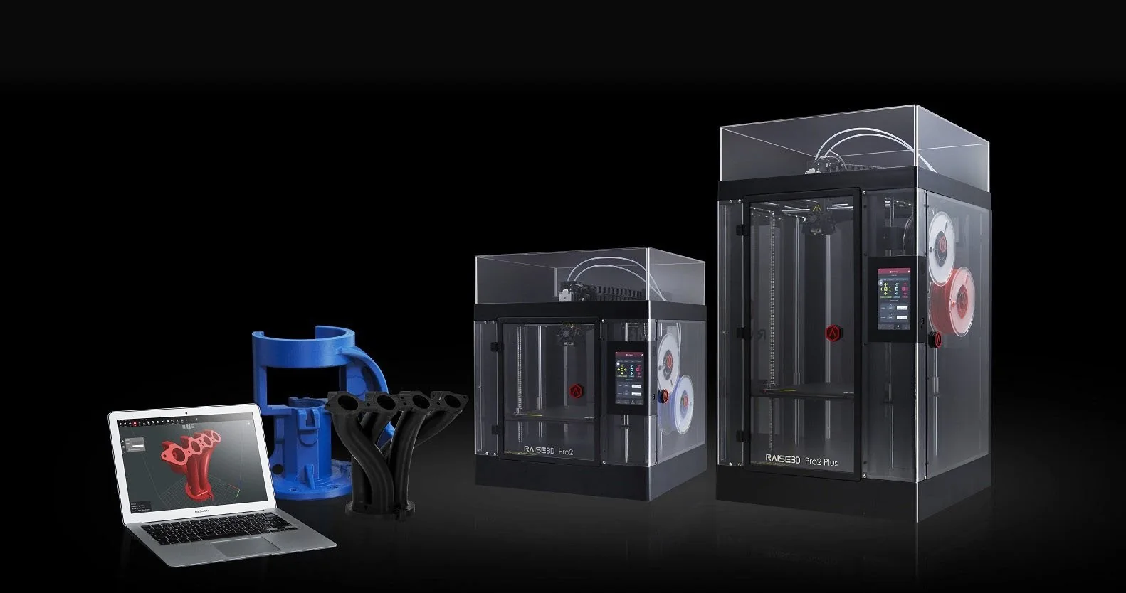 Two professional 3D printers beside printed engineering parts and a CAD workstation